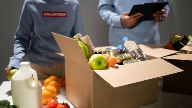 Volunteers packing food and supplies into donation boxes, representing how Seattle businesses support nonprofits and drive community impact in 2025.