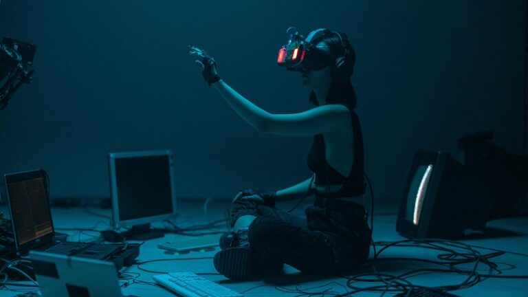 Person using advanced technology in a dark workspace, representing Seattle’s innovative CSR culture and tech-driven sustainability initiatives.